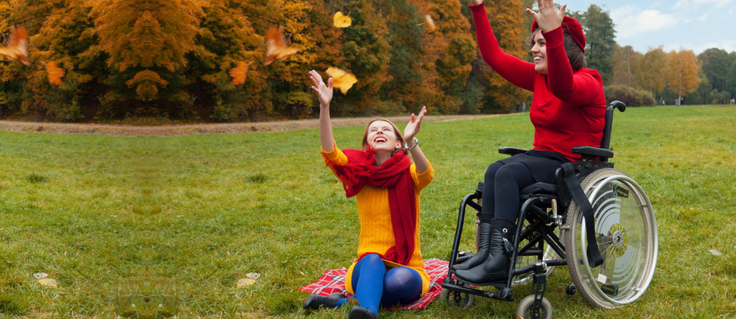 caregiver and patient in a wheelchair playing outdoor