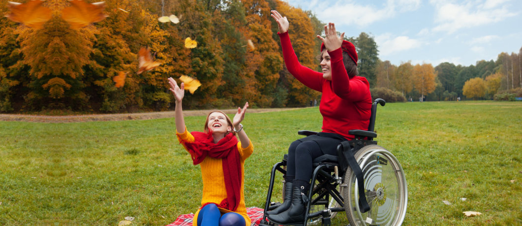 caregiver and patient in a wheelchair playing outdoor