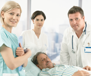medical staffs and elderly man in bed
